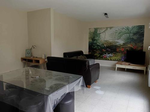 ein Wohnzimmer mit einem Sofa und einem Tisch in der Unterkunft MAISON 4 CHAMBRES AVEC JARDIN in Dampierre-en-Burly