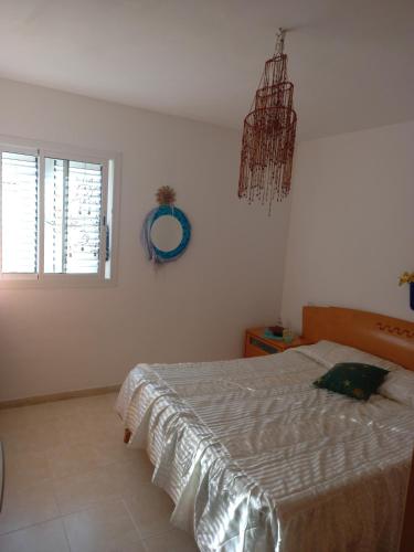 a bedroom with a bed and a window and a mirror at Mística INTERNET in Arona