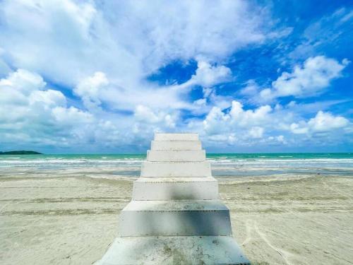 a concrete staircase on a beach with the ocean at Cloud9 Studio Tiara Desaru in Desaru