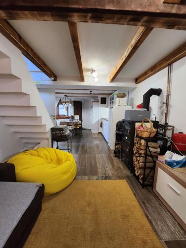 a living room with a yellow bean bag at Ház a szígeten in Fonyód
