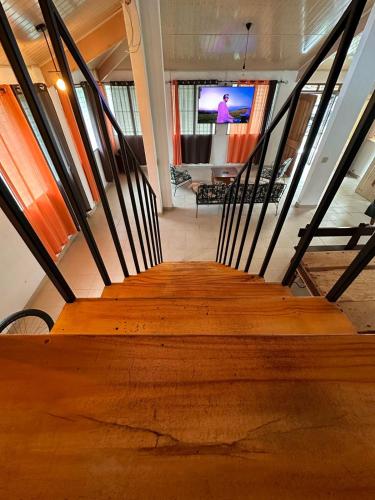 a staircase in a building with a person on the television at Blasina el valle in Valle de Anton