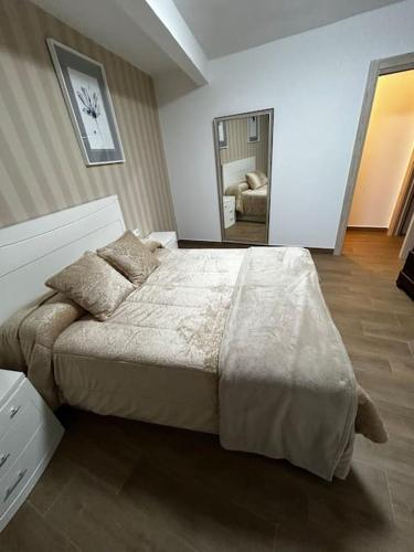 a bedroom with a large bed in a room at El Coso in Santa Cruz de la Zarza