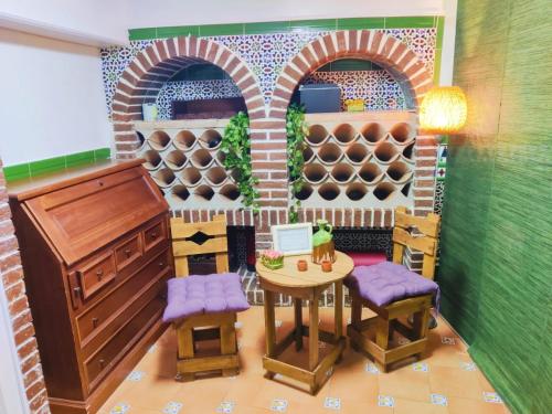 a lego kitchen with a table and a wine cellar at Lola´s winery house, andalusian patio in Granada
