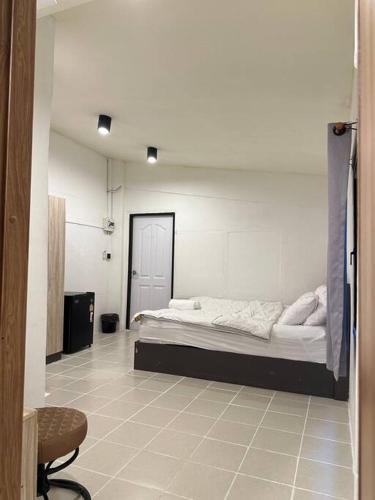 a bedroom with a bed in the middle of a room at Chubby 5 Room 5 in Bangkok