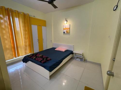 a bedroom with a bed with a blue blanket at Merlin Legacy in Kolkata