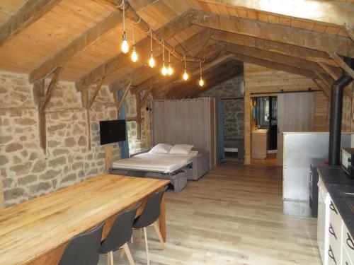 un salon avec une table et un lit dans l'établissement Gîte 5 personnes en Ardèche, à Beauvène