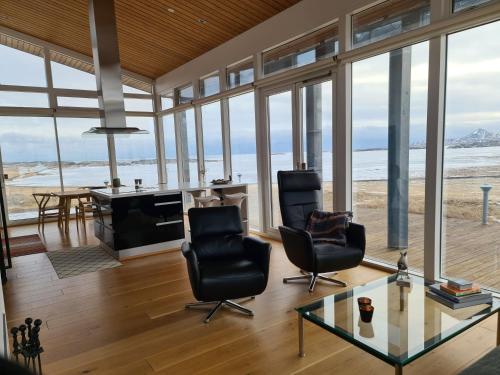 an open living room with a view of the ocean at Geithellar in Djúpivogur