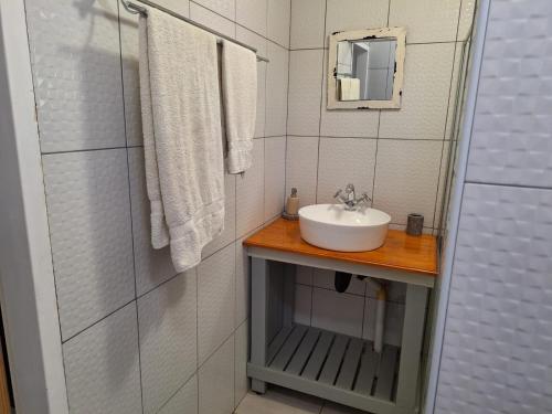 ein weißes Badezimmer mit einem Waschbecken und einem Spiegel in der Unterkunft 1@Kruger in Mokopane