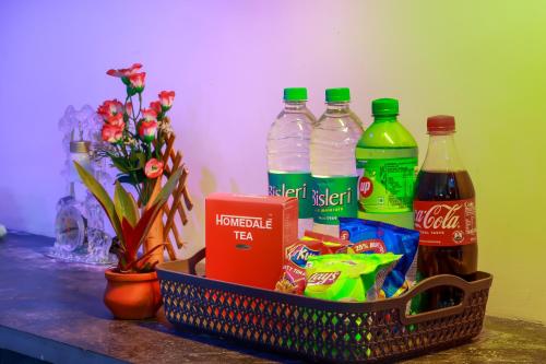 a basket filled with drinks and snacks on a counter at Hotel Five Laurels in Yercaud