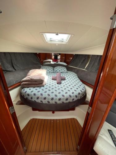 a large bed in the back of a boat at Nuit insolite Vieux-Port - Linge & ménage inclus in La Rochelle