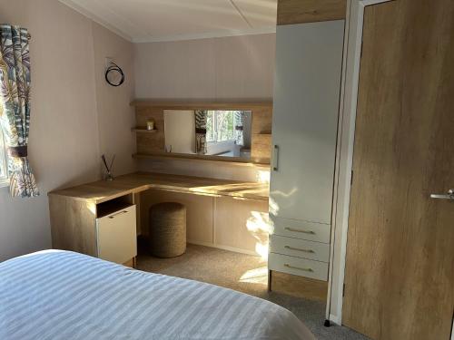 a bedroom with a bed and a desk in it at White Cross Bay Deer View in Windermere