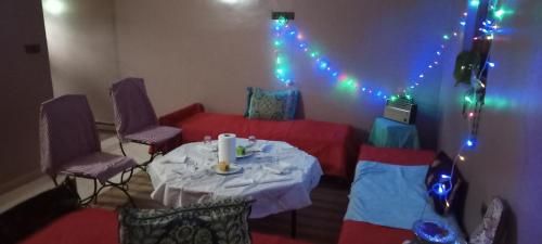 a room with a table and chairs and lights at SAHARA EXPERTISE in Tagounite