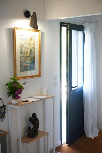 a room with a desk and a blue door at La Petite Maison in Villeconin