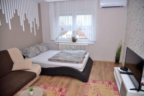 Ένα ή περισσότερα κρεβάτια σε δωμάτιο στο Apartman ANA