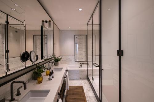 a bathroom with two sinks and a shower at Umiltà 36 in Rome