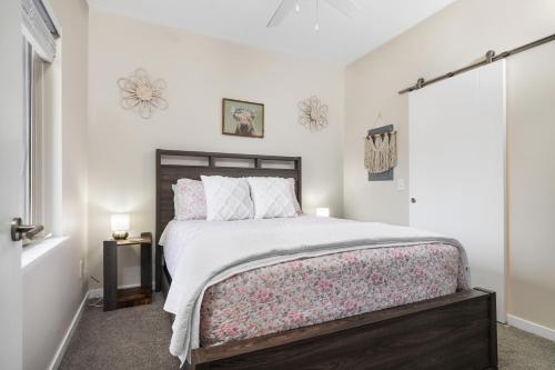 a bedroom with a large bed and a window at Sweet Tart Spot - Cozy TC Condo - Pet Friendly in Traverse City