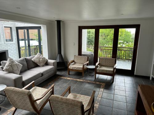 a living room with a couch and chairs at Clarens Tranquil Mountain Villa in Clarens
