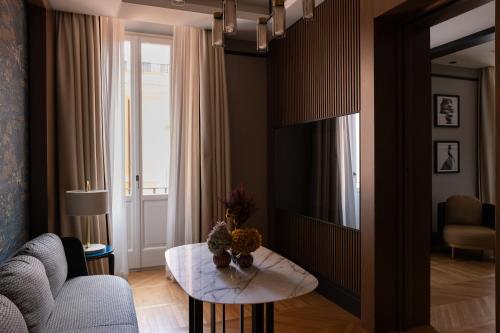 a living room with a couch and a table at Umiltà 36 in Rome