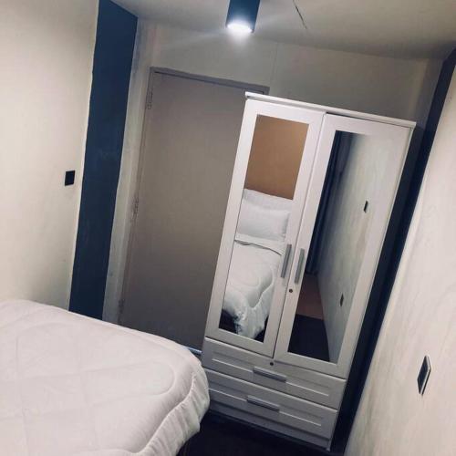 a bedroom with a mirror next to a bed at Chubby5 Room 7 in Bang O