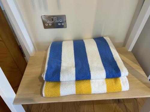 a towel sitting on a table in a room at Immaculate Studio Apartment just outside Penzance in Penzance