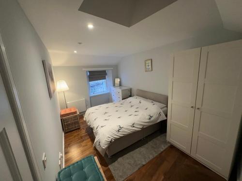 a small bedroom with a bed and a window at One Bee in Edinburgh