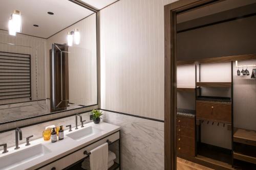 a bathroom with two sinks and a mirror at Umiltà 36 in Rome