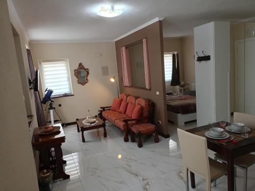 a living room with a red couch and a table at Il nido di Ele in Stresa