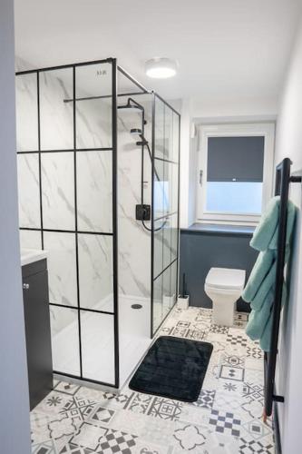 a bathroom with a shower and a toilet at The Porty Beach House in Edinburgh