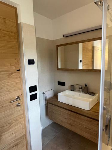 a bathroom with a sink and a mirror at Ciasa Valiares in San Vigilio Di Marebbe