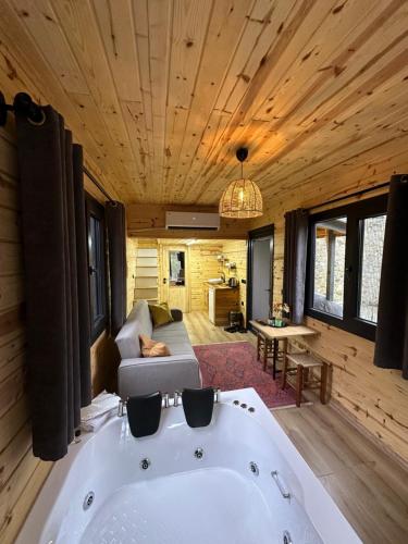 a large bath tub in a room with wooden ceilings at Nayon Tiny House in Rize