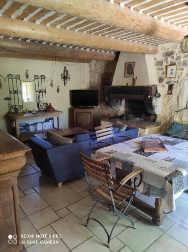 a living room with a blue couch and a table at La Crozette - Mas Provençal in Saint-Restitut
