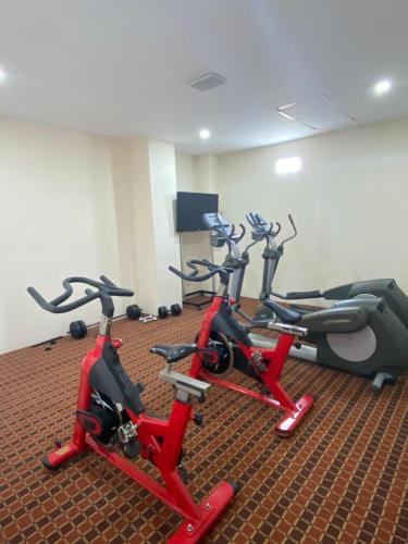 a gym with three exercise bikes in a room at Paris FC Express in Poza Rica de Hidalgo