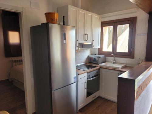 a kitchen with a stainless steel refrigerator and a sink at VILLA PEDRAZA ll in Rades de Abajo