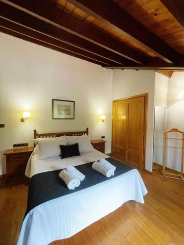 a bedroom with a large bed with two pillows at Pensión Casa Morán in Benia