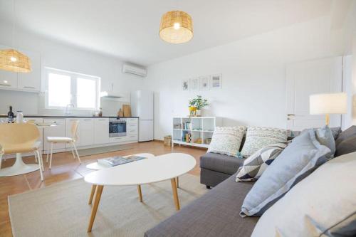 a living room with a couch and a table at Alethea's Sea View Apartment in Kalamaki