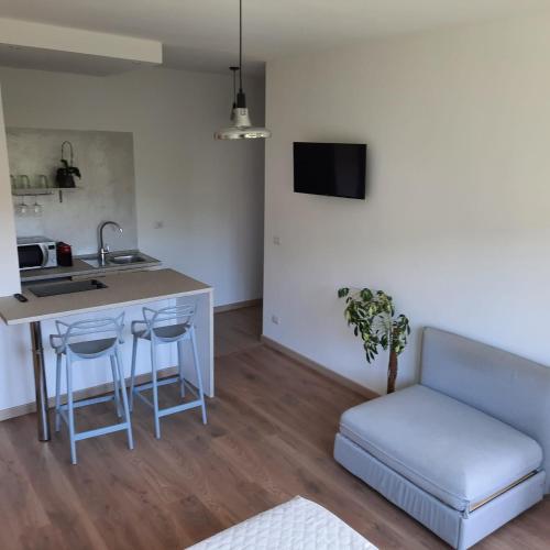 a kitchen with a sink and a table and a couch at Sprio House in Omegna