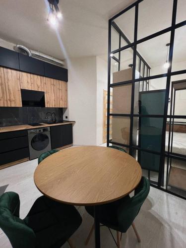 a kitchen with a table and chairs in a room at Апартаменти Loft на Лесі Українки 7,головна площа in Lviv