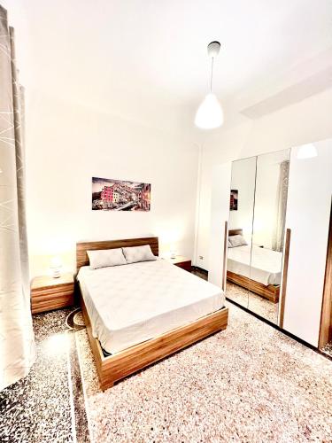 a bedroom with a bed and a mirror at A due passi da Brignole in Genoa