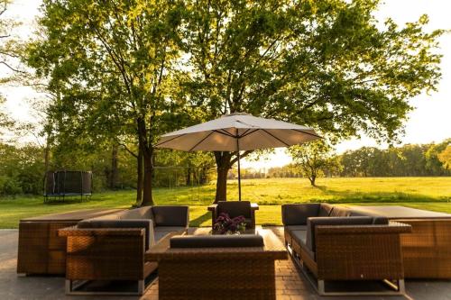 a patio with a table and an umbrella at Spreewald Chalet in Burg