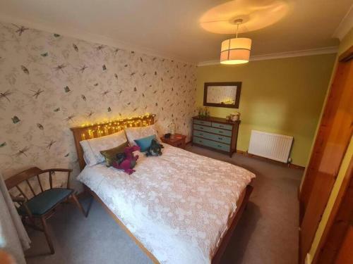 a bedroom with a bed with two stuffed animals on it at Peaceful Getaway In Peebles in Peebles