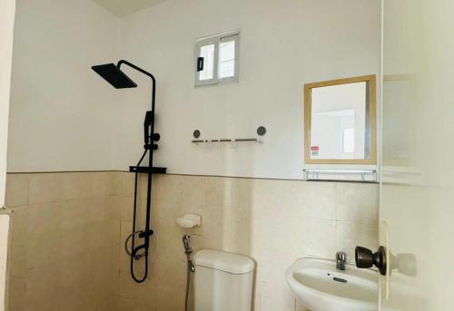 a shower in a bathroom with a toilet and a sink at Camella Mabini Cabanatuan in Cabanatuan