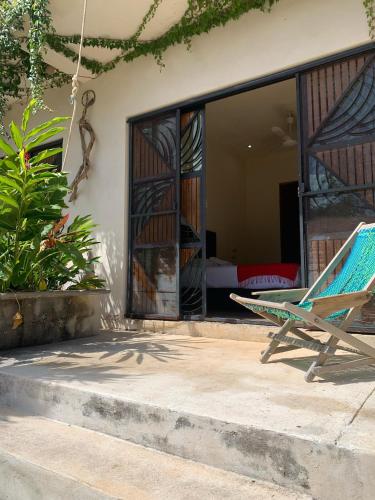 a blue chair sitting in front of a house at Casa Delfín Tulum in Macario Gomez