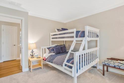 a bedroom with a white bunk bed in a room at Gorgeous Creek Side Ranch-Style Estate With Dock in Grasonville