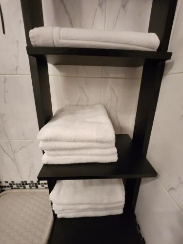 a pile of towels on a shelf in a bathroom at Apartma CIK in Bovec