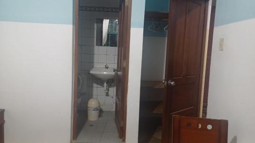 a small bathroom with a sink and a toilet at Julia house in Huanchaco