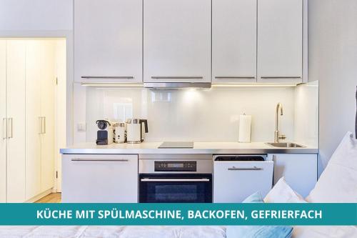 a kitchen with white cabinets and a counter top at Apt Wahnfried Nr1 - Cityapartment mit Küche, Duschbad, Balkon, Parkplatz - zentral aber ruhig in Bayreuth