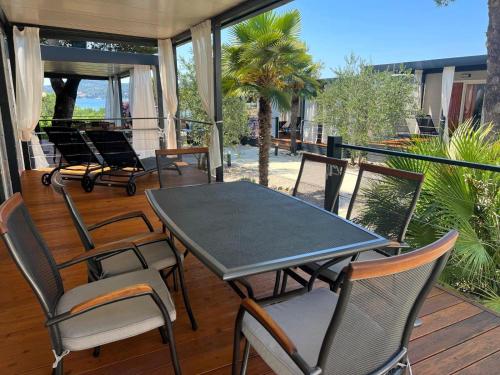 einen Tisch und Stühle auf einer Veranda mit Aussicht in der Unterkunft Dalmaris camp - prestige mobile homes Biograd na Moru in Biograd na Moru