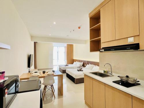 a kitchen and a living room with a couch at The Shore Maison Life 小居屋 in Kota Kinabalu