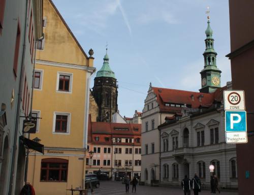 a city street with buildings and a clock tower at City-Appartement Pirna in Pirna
