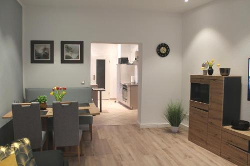 a living room and dining room with a table and chairs at City-Appartement Pirna in Pirna
